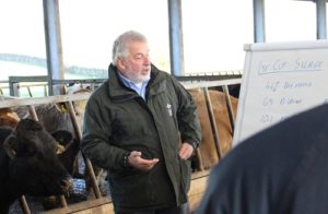 Man giving a presentation in a cattle shed