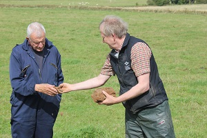 Advisor handing around soil during meeting