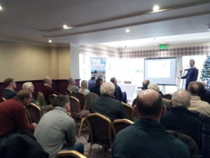 conference room full of farmers listening to a presentation