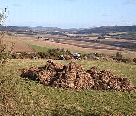 a field heap midden in the middle of a field