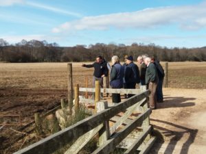 Farmers on a farm walk looking into a field during the Soil Management and River Dee Priority Catchment update event 