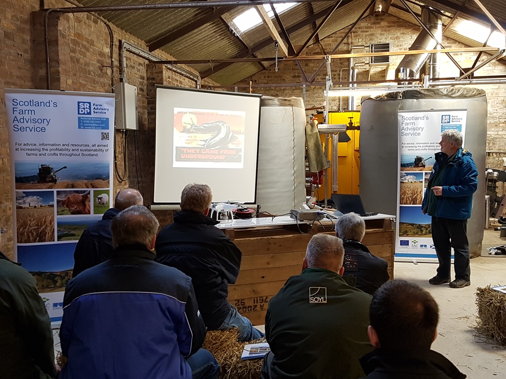 Farmers watching presentation slides by Andy Evans discussing ICM of slugs and pests at the Laurencekirk ICM event