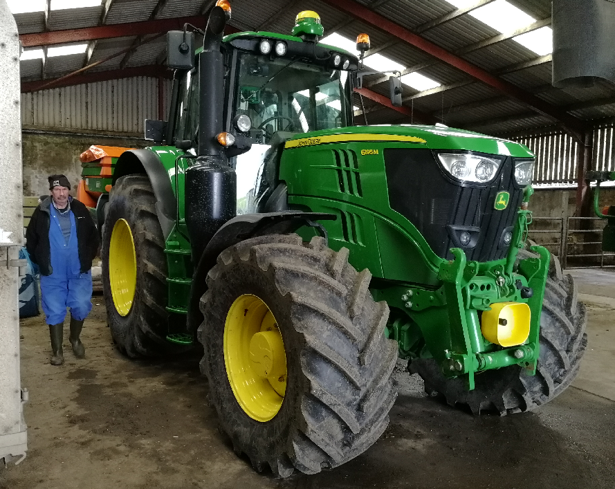 Photo of a John Deere tractor inside a machinery shed