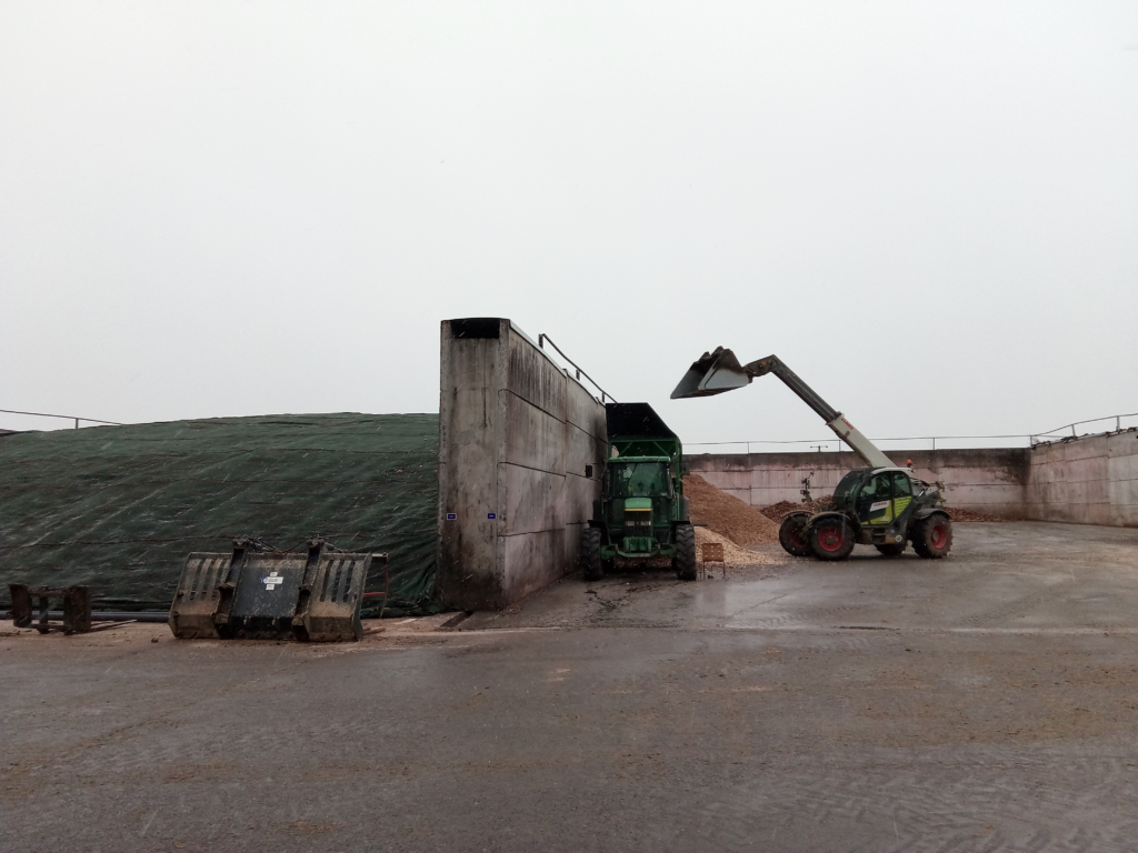 Photo of two silage pits at Bogindollo Farm, one full and fully covered, the other has a telehandler working in it.