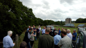 Group of farmers beside a watercourse in a grassland field at the Lothians Priority Catchment meeting at Hagbrae farm