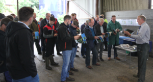 Group of farmers looking through the Valuing Your Soils booklet