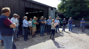 A group of farmers standing in front of a farm shed during the Priority Catchment meeting at Hagbrae