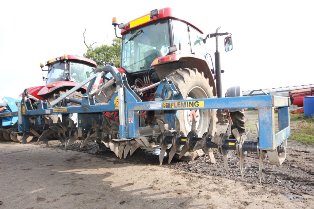 Soil aerator attached to a Case Tractor