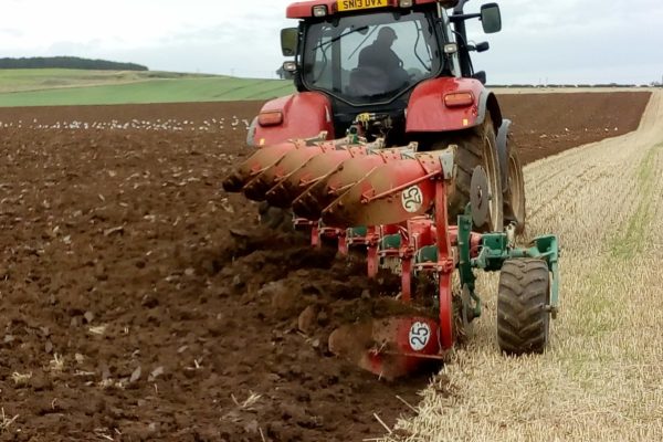 A Case tractor ploughing a field at Bielgrange, the East Lothian Soil & Nutrient Network host farm