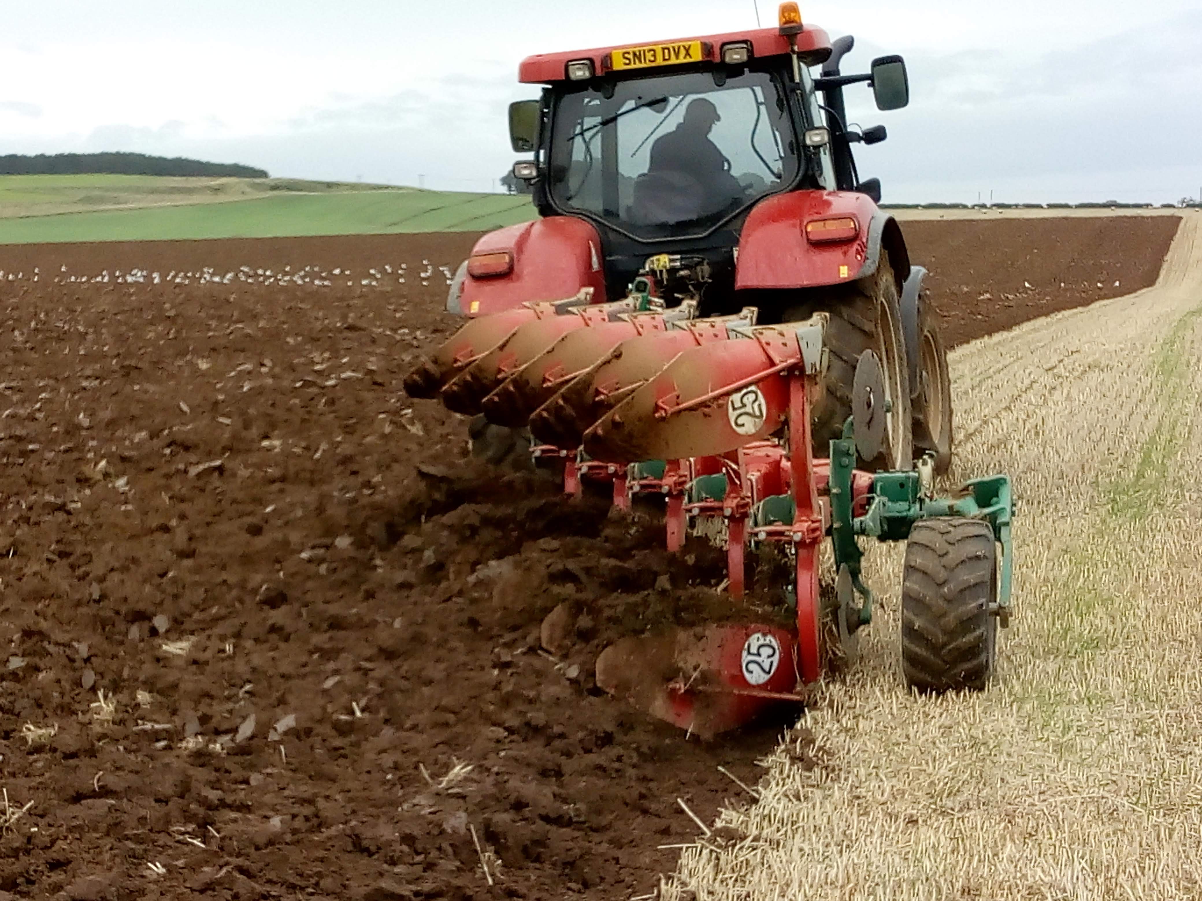 A Case tractor ploughing a field at Bielgrange, the East Lothian Soil & Nutrient Network host farm