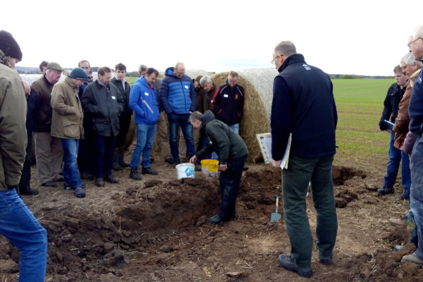 An open soil pit at Bielgrange, the host farm for the East Lothian Soil & Nutrient Network. Brian Griffiths is showing a group of farmers the different soil structure within the ground