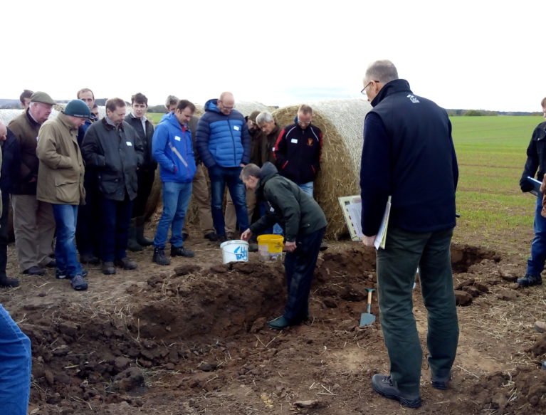 An open soil pit at Bielgrange, the host farm for the East Lothian Soil & Nutrient Network. Brian Griffiths is showing a group of farmers the different soil structure within the ground