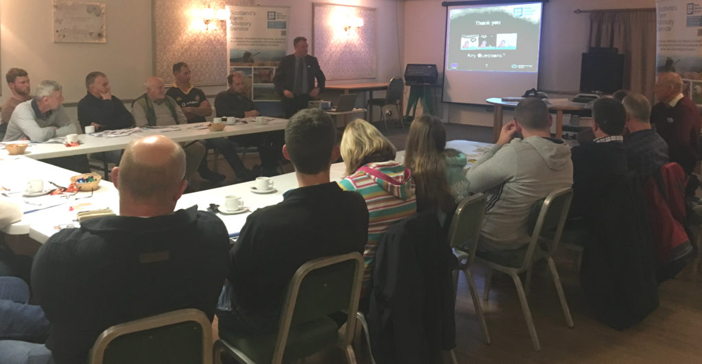 Stranraer Soil & Nutrient Network - second meeting - a group of farmers sitting around a table listening to a presentation from Dr Paul Hargreaves