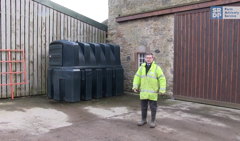 Drainage expert Gavin Elrick standing in a steading beside a bunded fuel tank
