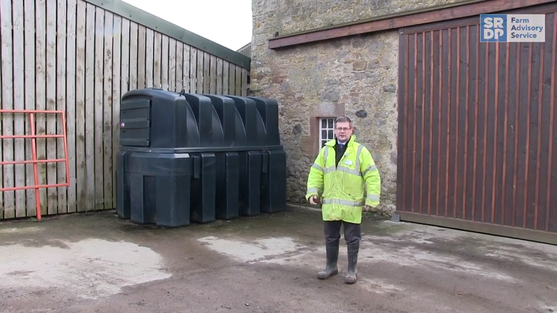 Drainage expert Gavin Elrick standing in a steading beside a bunded fuel tank