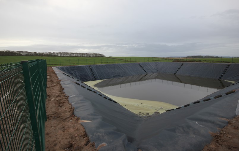 Slurry lagoon with safety fence