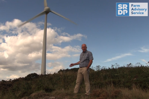 Jim Campbell standing in front of a wind turbine 600x400