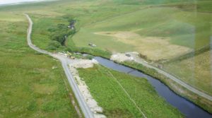 Upland river with roadway running alongside