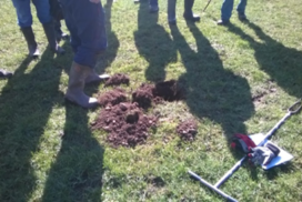 Wormiston Farm - assessing soil structure, people's feet standing around a soil pit