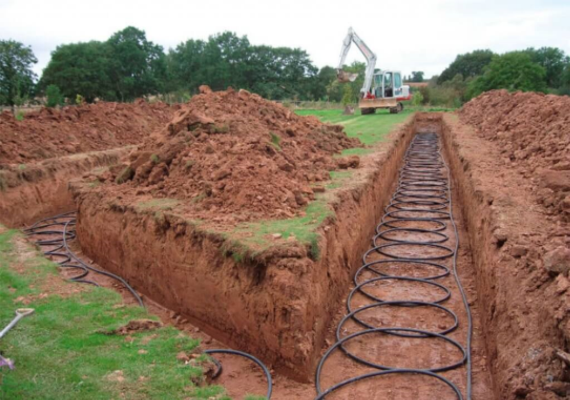 Trench with solar cables and digger