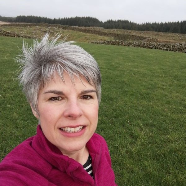 Smiling woman with green field in the background