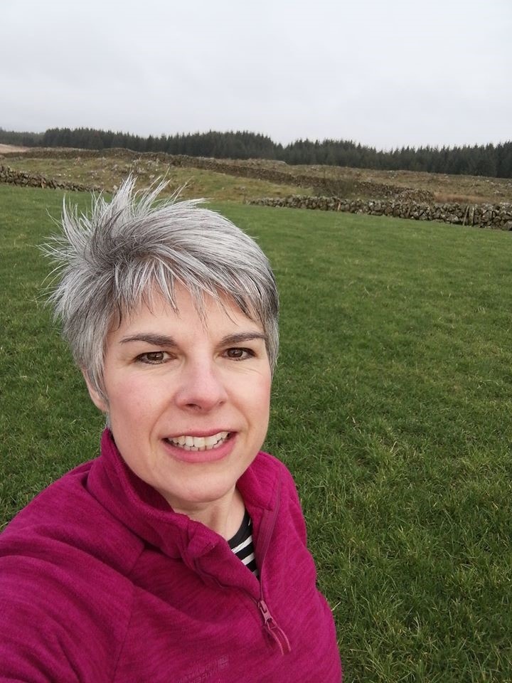 Smiling woman with green field in the background