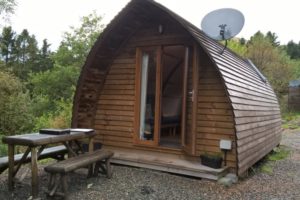 Wigwam glamping pod with picnic table on decking.
