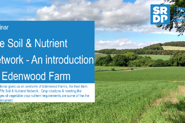 A photo of a title slide from the Fife Soil & Nutrient Network webinar held in July. There are green arable fields in the background with trees lining the field perimeters, the sky is bright blue with fluffy white clouds and the foreground is filled with a blue title box filled with the words 'Fife Soil & Nutrient Network - an introduction to Edenwood Farm'.