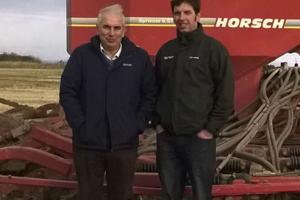 Two farmers stood in front of a Horsch Sprinter 6ST tine seeder