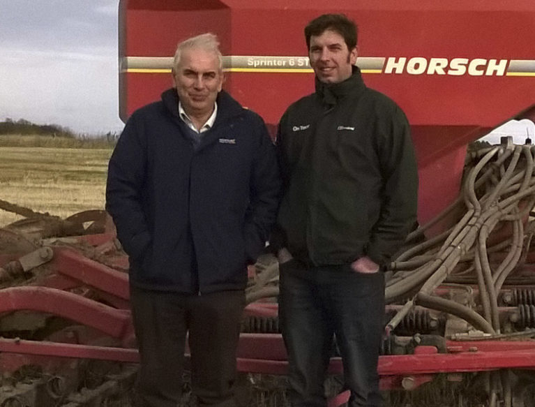 Two farmers stood in front of a Horsch Sprinter 6ST tine seeder