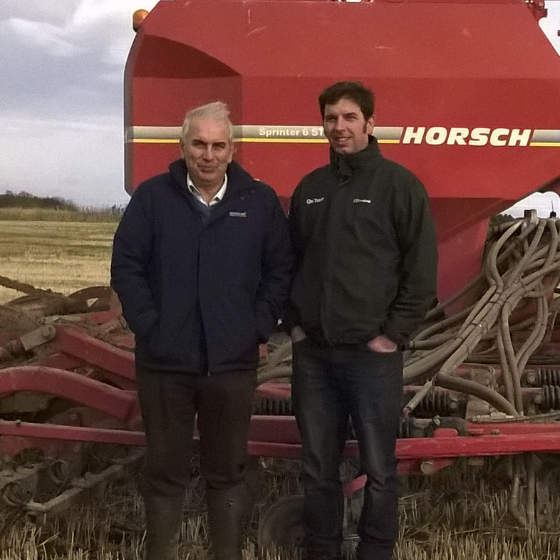 Two farmers stood in front of a Horsch Sprinter 6ST tine seeder