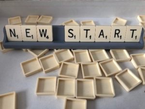 Scrabble letters spelling NEW START