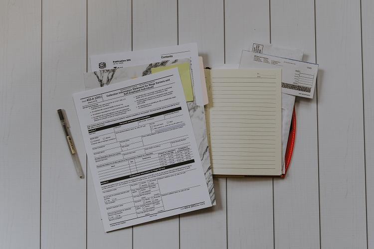 Selection of papers, forms and a notebook gathered as part of an audit trail