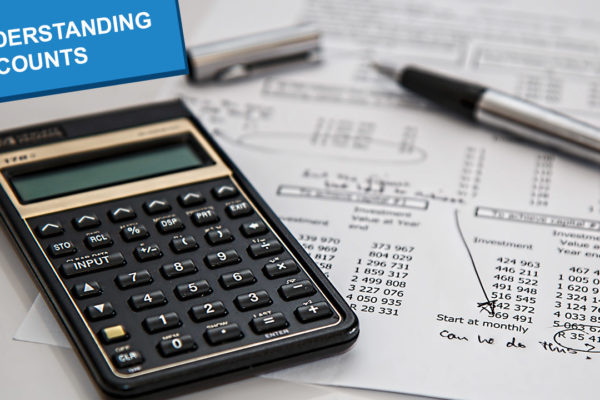 A calculator and financial documents, with the title 'understanding accounts'