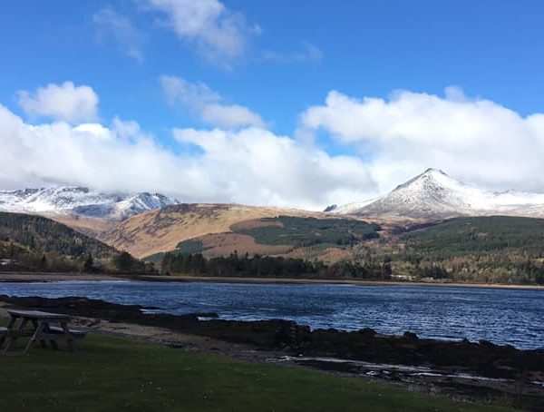 View of Arran hills covered in snow with sea in the forefront