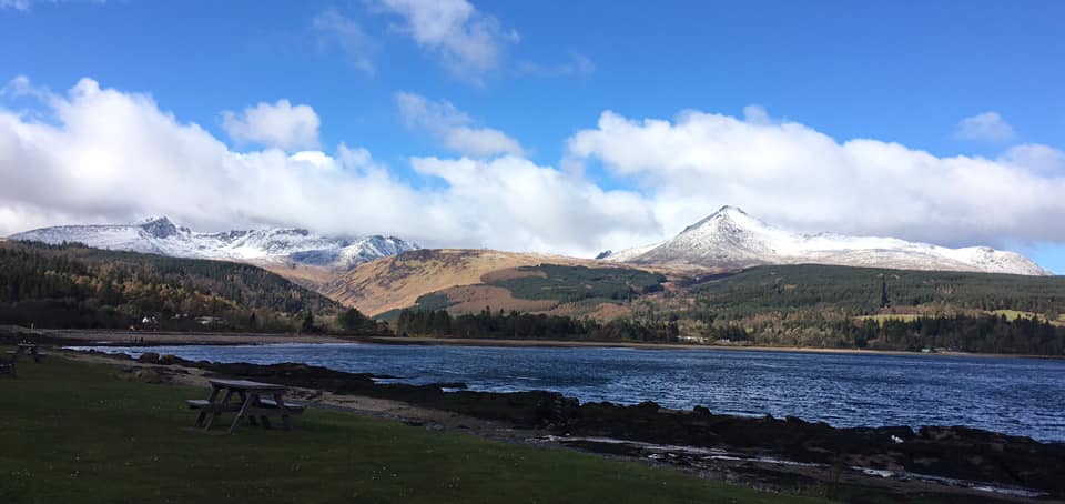 View of Arran hills covered in snow with sea in the forefront