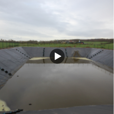A slurry pit with banked sides.