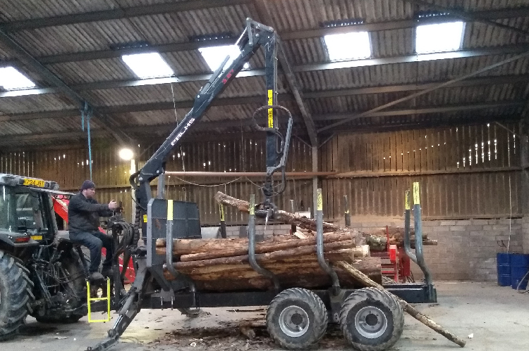 A Palms timber trailer with grab for moving logs