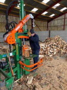 Farm Advisory Service - a man operating a Posch 20t Hydrocombi Firewood Log Splitter with a pile of split logs behind him A man operating a Posch 20t Hydrocombi Firewood Log Splitter with a pile of split logs behind him