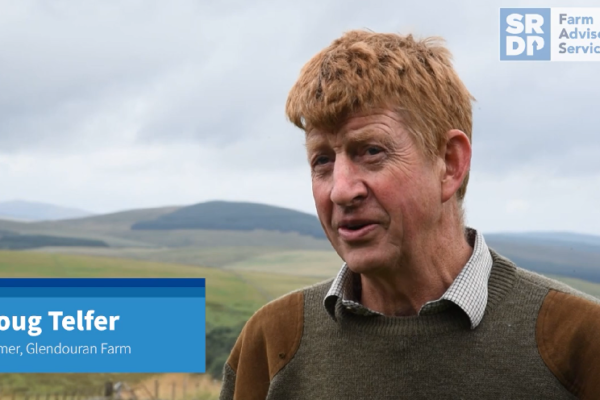 Doug Telfer, a farmer who has farmed at Glendouran Farm for all of his life, standing in a grassland field and talking to someone who is slightly behind the camera.