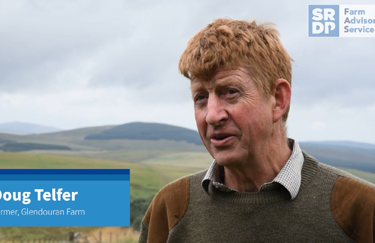 Doug Telfer, a farmer who has farmed at Glendouran Farm for all of his life, standing in a grassland field and talking to someone who is slightly behind the camera.