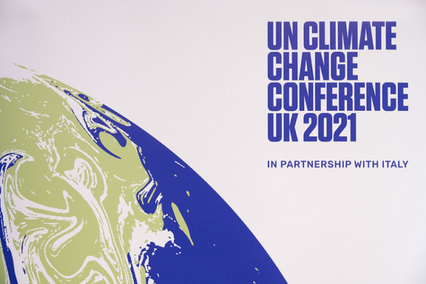 On a white background sits a characteristic image of a globe with the words UN Climate Change Conference UK 2021 in partnership with Italy. The image has been produced by the US Embassy.
