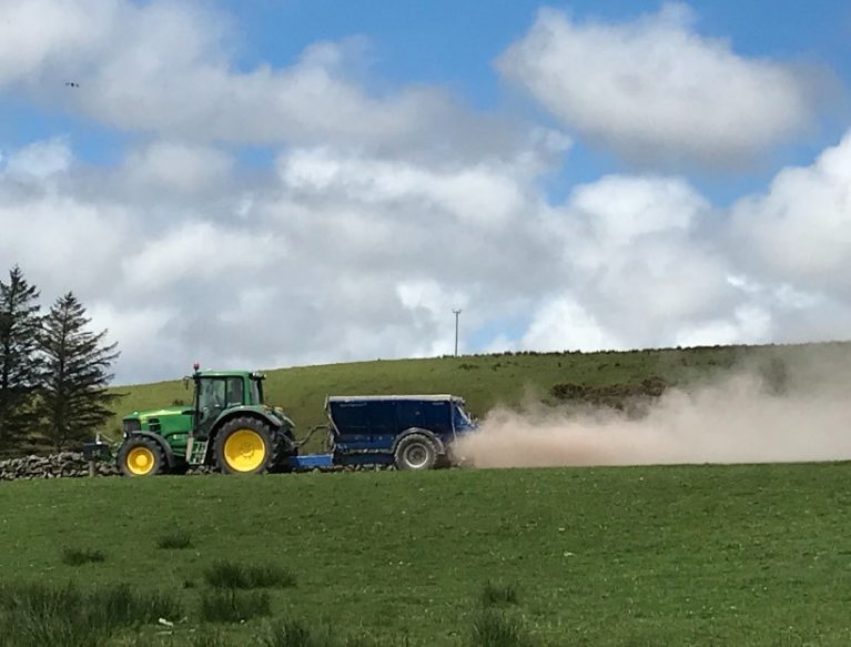 Tractor spreading lime