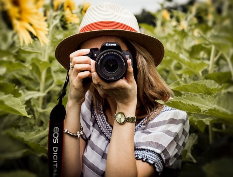 Lady holding a camera and taking a picture