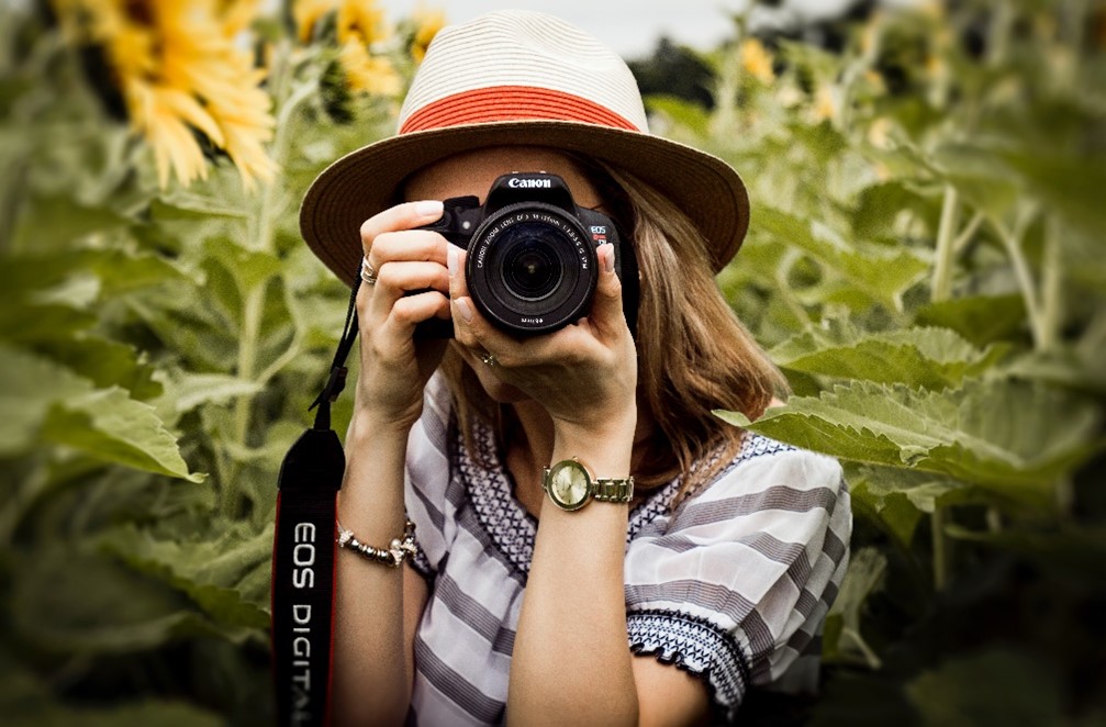 Lady holding a camera and taking a picture