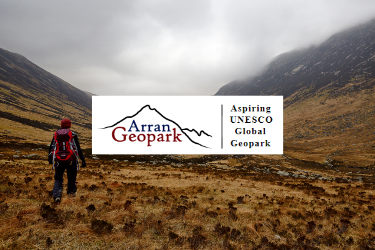 A hiker walking through a valley on the Isle of Arran. Photo has been overlaid with the Arran Geoparks logo on a white background.