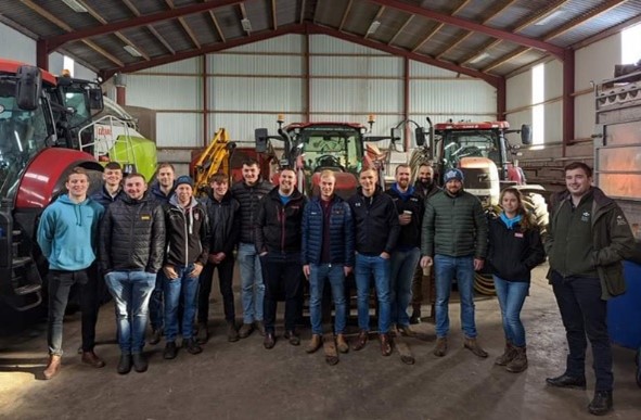 Group of farmers standing in a shed