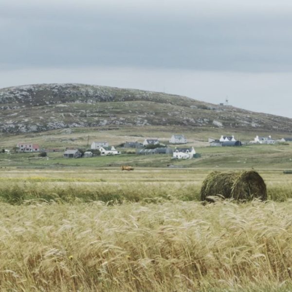 View of croft houses at the base of a hill