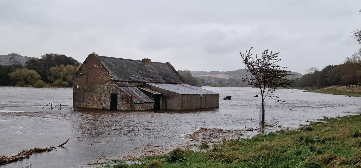 Flood water surrounding a cottage
